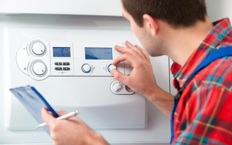 Technician servicing the gas boiler for hot water and heating