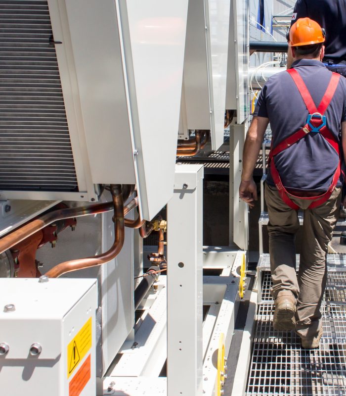 plumbers at work installing a chiller in an industry